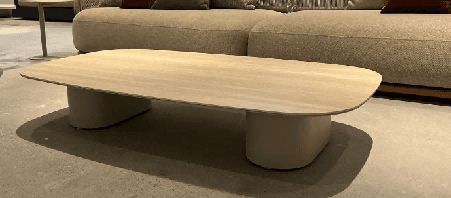 A modern outdoor sofa with a light grey upholstered base, woven rope arms and back, and several throw pillows in varying shades of grey, brown, and off-white.