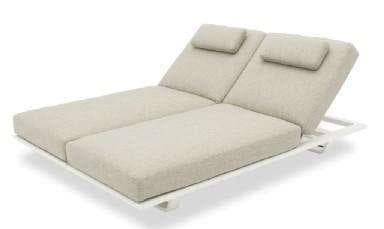 A light-colored outdoor chaise lounge with a padded cushion and an adjustable backrest is shown on a white background.