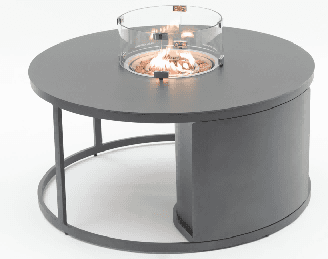 A black cast iron grill plate with a ridged surface sits on a silver metal stand with three legs and a circular base.