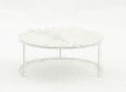 A round coffee table with a white top and a simple, light-colored metal base is presented against a plain white background.