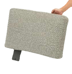A person's hand holds a rectangular, light gray upholstered cushion with dark gray metal legs attached to its underside.